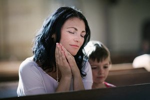 graphicstock beautiful woman with her son praying in the church BRegP k0Wb thumb