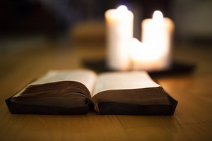 graphicstock close up of an old bible laid on wooden floor burning candles next to it H lYR3d8fW thumb 1
