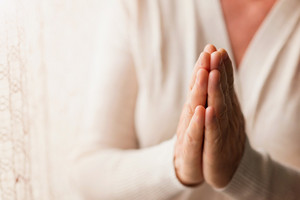 graphicstock hands of an unrecognizable woman in white cardigan praying r0xJrwQ6 Z thumb