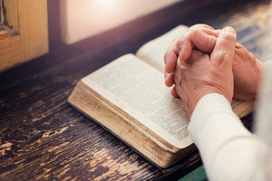 graphicstock unrecognizable woman holding a bible in her hands and praying rAiv mpW thumb 1