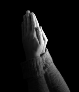 womans hands held up in prayer on black background Smbk0CWlR thumb