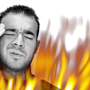 a man experiencing pain and suffering with hot fiery flames burning around him Htq z9RHi