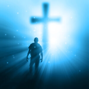 a man walking towards a cross with sunbeams HmWm1kzgA