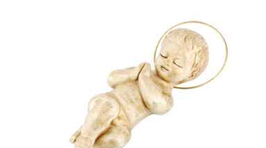 golden baby jesus lying on white QJ4lVE