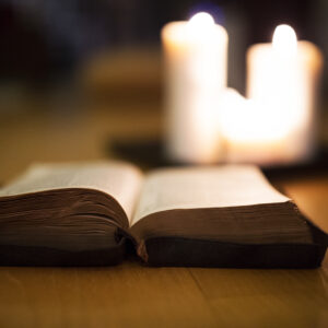 graphicstock close up of an old bible laid on wooden floor burning candles next to it H lYR3d8fW 2