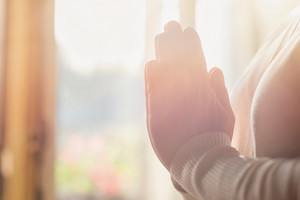 graphicstock hands of an unrecognizable woman standing by the window and praying HAT8PQaZb thumb