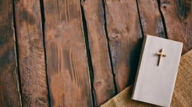 Spiritual Growth through Daily Devotionals: Cultivating a Closer Relationship with Christ 18 graphicstock image of christian book with cross on its cover on wooden background HBbfQtvsl