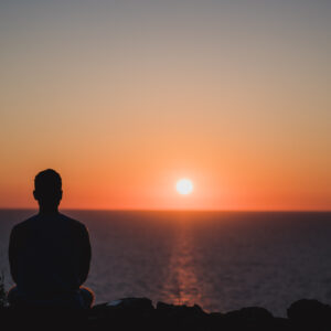 storyblocks young man looking to the sunset over sea enjoying and relaxing concept full of unforgettable experiences to recharge balance mind and body SuCIa8jXV