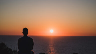 storyblocks young man looking to the sunset over sea enjoying and relaxing concept full of unforgettable experiences to recharge balance mind and body SuCIa8jXV