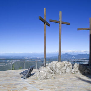 three wooden crosses on a viewing podium atop a mountain