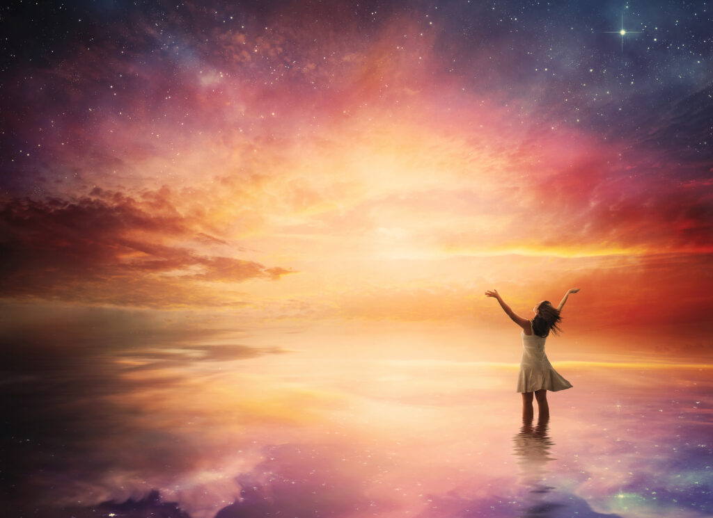 woman stands in praise before a beautiful night sky rmMqykGgC