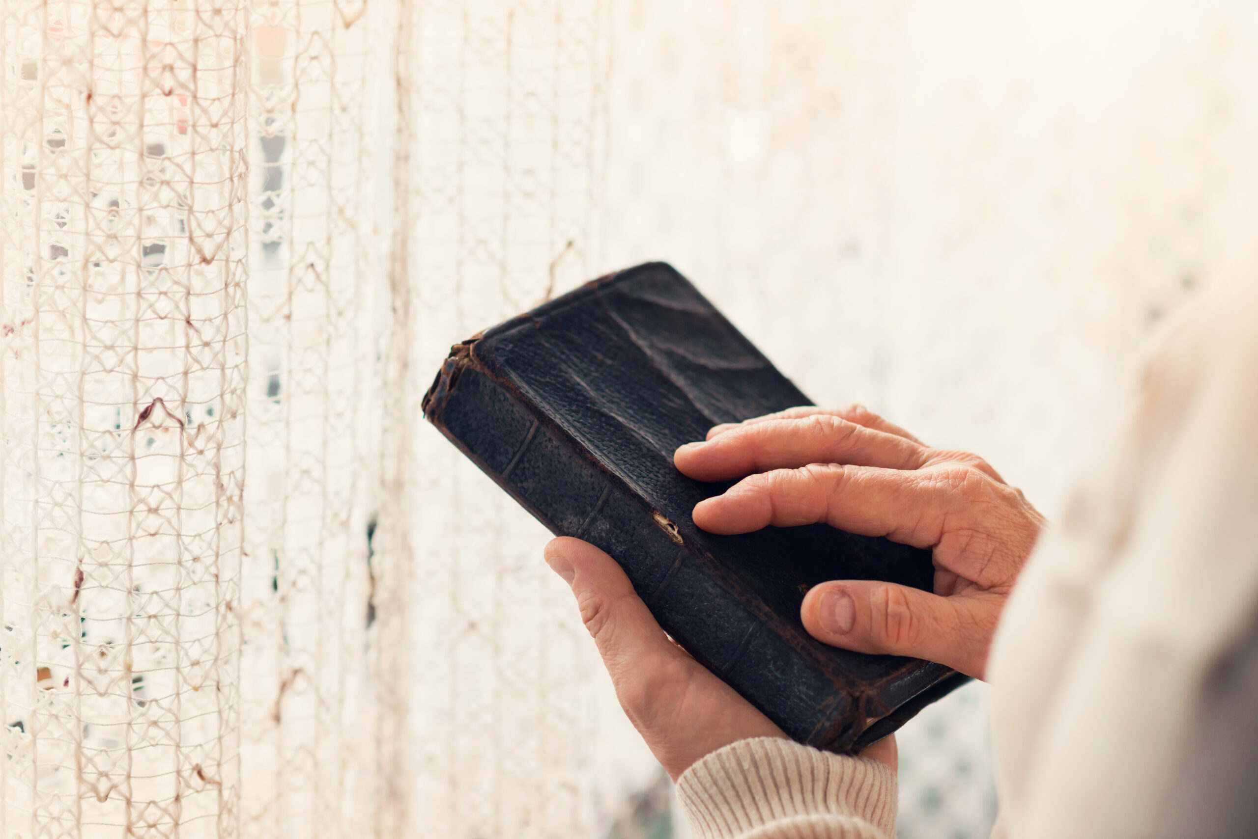 graphicstock unrecognizable woman holding a bible in her hands HRMhLuXaZZ scaled