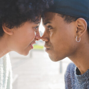 graphicstock young multiethnic couple outdoor in the city looking in the eye smiling love relationship trust concept HpgD5XnY1b