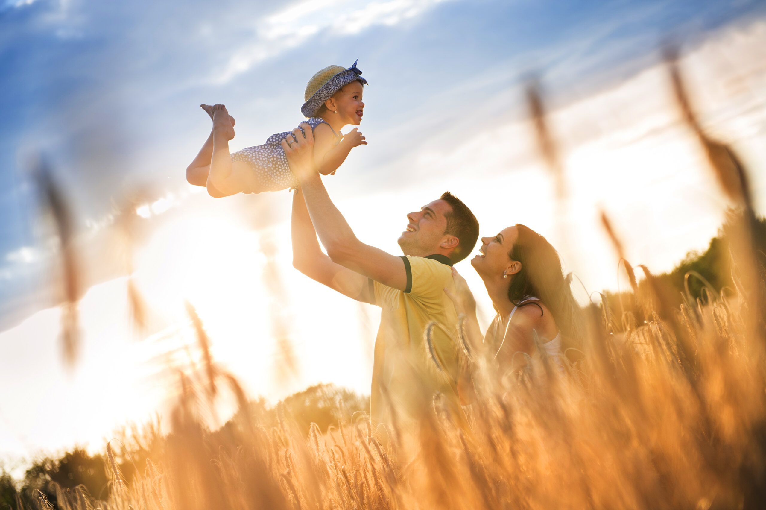 graphicstock happy pregnant family with little daughter spending time together in sunny field B0ln5gDhWZ scaled