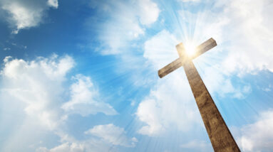 a wooden christian cross with bright sun and clouds HQIORRZxC 1