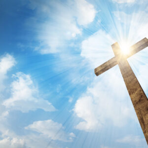 a wooden christian cross with bright sun and clouds HQIORRZxC