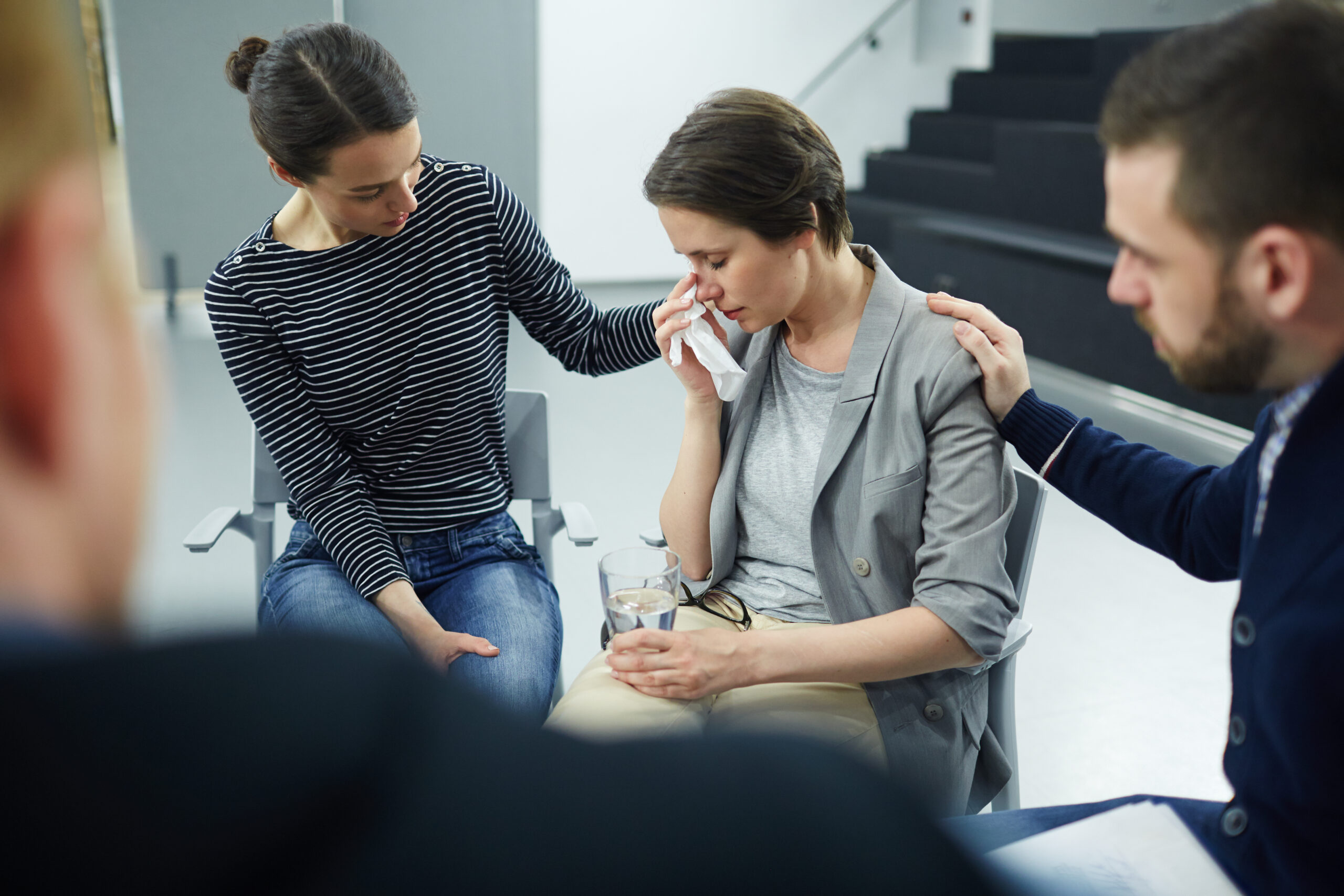 storyblocks stressed female wiping her tears with paper tissue while man and woman comforting her rnGOPdryyz scaled