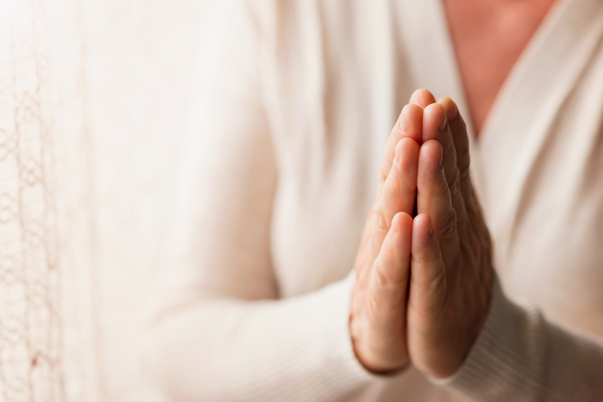 graphicstock hands of an unrecognizable woman in white cardigan praying r0xJrwQ6 Z scaled